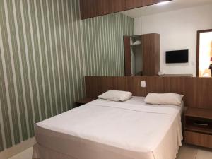 Giường trong phòng chung tại Hotel Encontro das Águas
