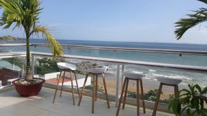 a balcony with chairs and a view of the ocean at Homestay coco in Vung Tau
