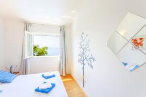 a white room with a bed and a window at Kuća za odmor MAJA in Tučepi +36 photos