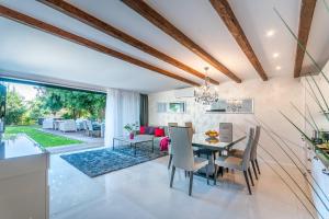 a dining room with a table and chairs at Villa Fema in Rovinj