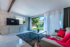 a living room with a couch and a tv at Villa Fema in Rovinj