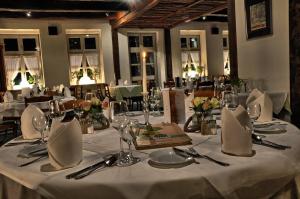 a table with white tablecloths and napkins on it at Hotel Alte Linden in Altena