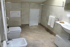 a bathroom with a toilet and a sink at Giulimà B&B in Rocchetta SantʼAntonio +19 photos
