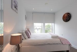 מיטה או מיטות בחדר ב-Deluxe Central London Apartment