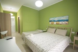 Ένα ή περισσότερα κρεβάτια σε δωμάτιο στο Lido Rosa Rooms