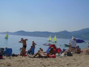 a group of people on a beach with boats in the water at Vllla Reva in Argelès-sur-Mer