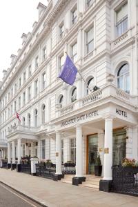 a large white building with a purple flag on it at Lancaster Gate Hotel in London