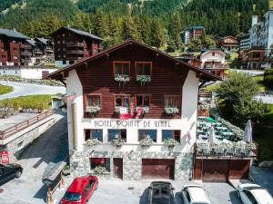 a building with cars parked in front of it at Pointe de Zinal in Zinal