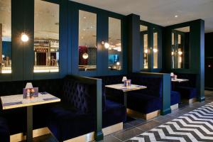 a dining room with blue booths and tables at Le Monde Hotel in Edinburgh