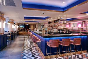 a bar in a restaurant with stools at Le Monde Hotel in Edinburgh