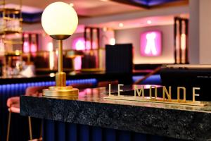 a bar with a table with the words lime wound at Le Monde Hotel in Edinburgh