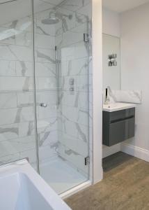 a bathroom with a shower and a sink at Sanderson Suites in Harrogate