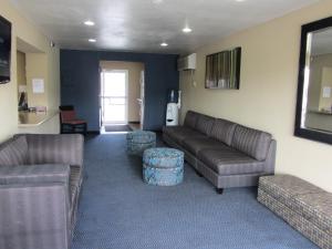 a living room with a couch and two chairs at Howard Johnson by Wyndham Odessa TX in Odessa