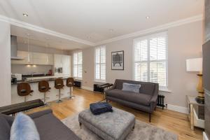 a living room with a couch and a table at Belford by Harrogate Serviced Apartments in Harrogate