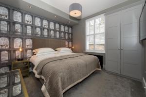 a bedroom with a large bed and a window at Belford by Harrogate Serviced Apartments in Harrogate