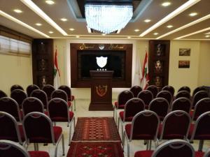 a room with chairs and a podium with a stage at Grand Gabriel in Jounieh