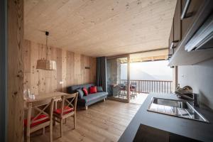 uma cozinha e sala de estar com um sofá e uma mesa em Kristplonerhof em Bolzano