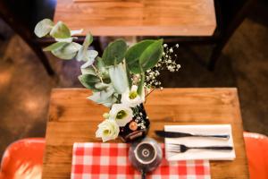 a table with a vase with flowers on it at Hôtel Le G (ex Le Genève) in Nice