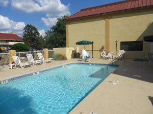 a swimming pool in front of a building at Fairview Inn & Suites Mobile in Mobile