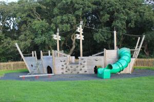 a playground with a slide in a park at Moonlight Ridge -2 bedroom lodge with hot tub in Felton