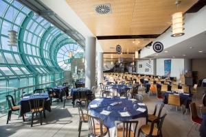 a dining room with blue tables and chairs at TH Sestriere - Villaggio Olimpico in Sestriere