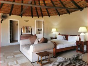 a living room with a couch and a bed at Riverside Manor in Nottingham Road