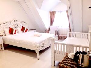 a bedroom with two white beds and a window at 39 Living in Bangkok