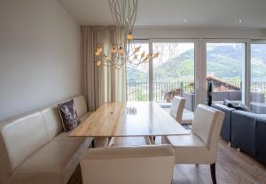 a dining room with a table and a couch at Apartments Drei Türme in Schruns-Tschagguns