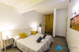 Un dormitorio con una cama con almohadas amarillas. en Apartments Vista Maritima By Villas Now Ltd, en Playa Blanca