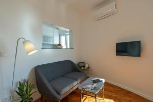 a living room with a couch and a tv at MyPlaceLisbon - Tágides River View in Lisbon