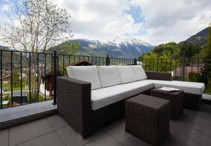 a couch on a balcony with a view of a mountain at Apartments Drei Türme in Schruns