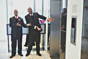 two men in suits standing in front of a mirror at WeStay Westpoint Apartments in Johannesburg +72 photos