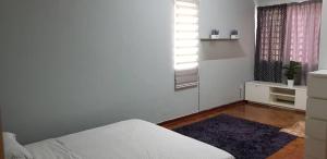 מיטה או מיטות בחדר ב-Tun Perak Homestay