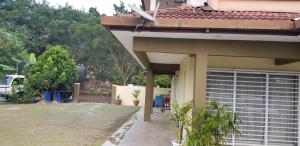 a side view of a house with a garage at Tun Perak Homestay in Rawang