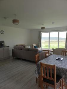 a living room with a table and a couch at Cottiscarth Cottages in Finstown