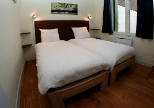 Ένα ή περισσότερα κρεβάτια σε δωμάτιο στο Apparthotel Douai Gare
