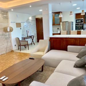 a living room with a couch and a table at Modern 2 bed room large apartment in Nicosia
