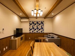 a conference room with a table and a couch at Villa Ensoleille in Fujikawaguchiko