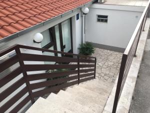a staircase with a wooden fence next to a house at Apartmani Mare in Split
