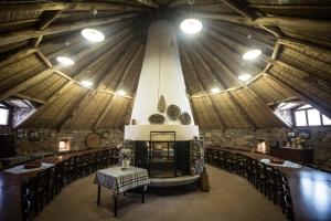 a large room with tables and chairs in a building at Agriturismo Sa Perda Marcada in Arbus