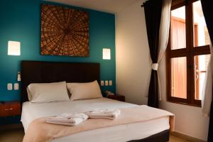 a bedroom with a bed with towels on it at Casa Ebano 967 in Cartagena de Indias +165 photos