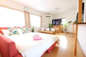 a bedroom with a large bed with a large window at Osaka - House / Vacation STAY 4824 in Osaka