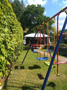 an empty playground withswing equipment in a park at Milennia Family Hotel in Sunny Beach