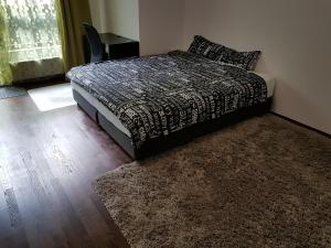a bedroom with a bed and a rug at MOne - fajny apartament w centrum Wrocławia in Wrocław