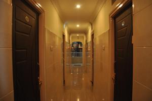a hallway with a mirror and a door at Hotel Sahasra Residency in Tirupati