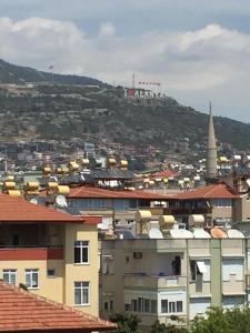 a view of a city with a hill in the background at Serendi Apart Hotel in Alanya