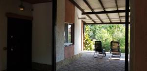 GoraTwins guest house near Boryspil airport في Hora: كرسيان يجلسون خارج المبنى