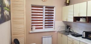 a kitchen with a window and a sink at GoraTwins guest house near Boryspil airport in Hora