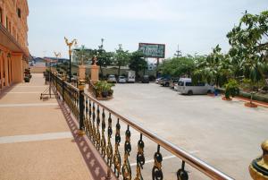 a metal railing in front of a parking lot at Rose Garden Hotel in Phra Nakhon Si Ayutthaya
