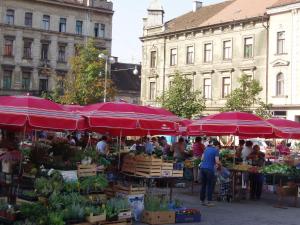 a farmers market with red umbrellas in a city at Guest House Ilicki Plac in Zagreb